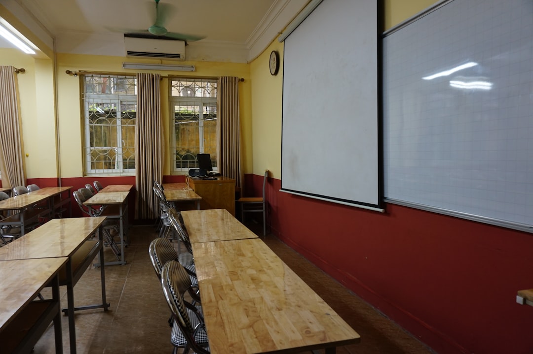 A classroom setting with students using AI tools on laptops