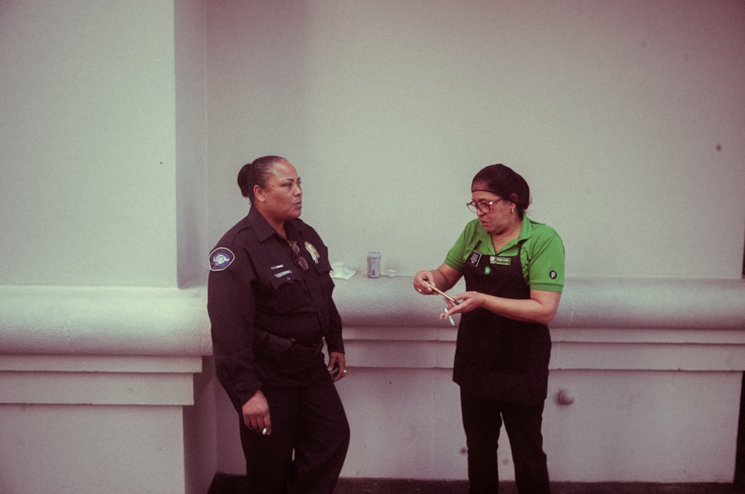 A police officer restraining the attacker at the town hall event