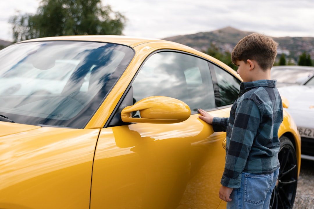 A family examining used cars at a dealership, illustrating affordability issues
