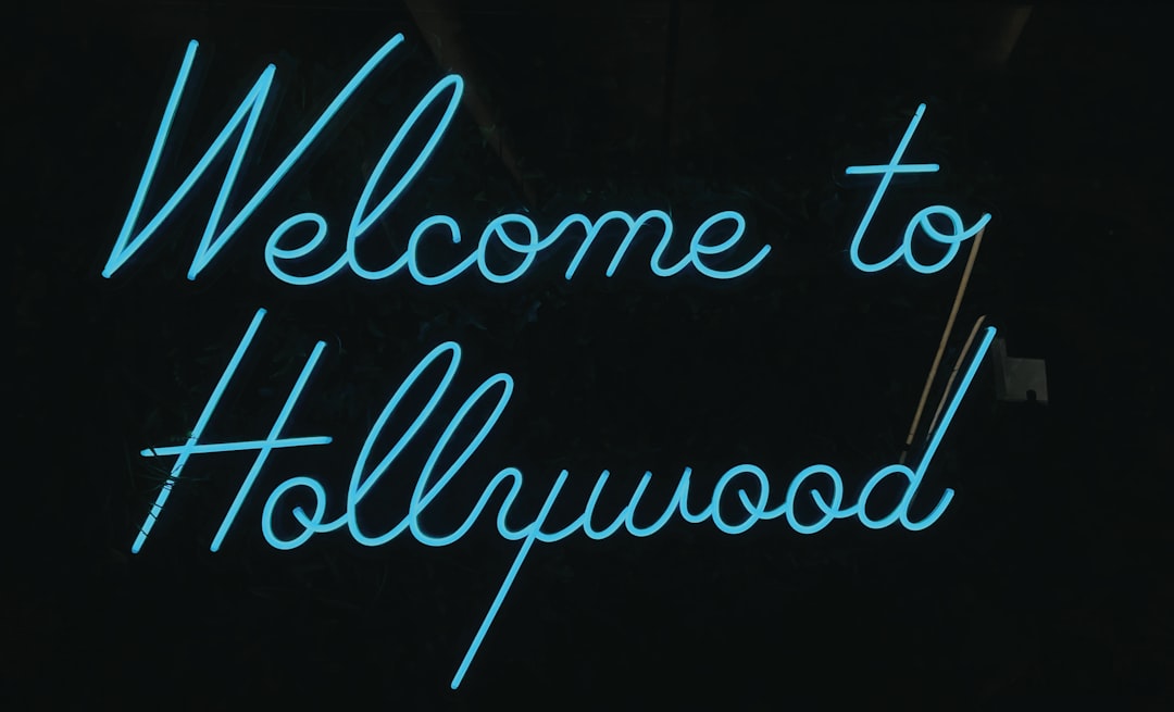 Hollywood sign with diverse actors gathered below