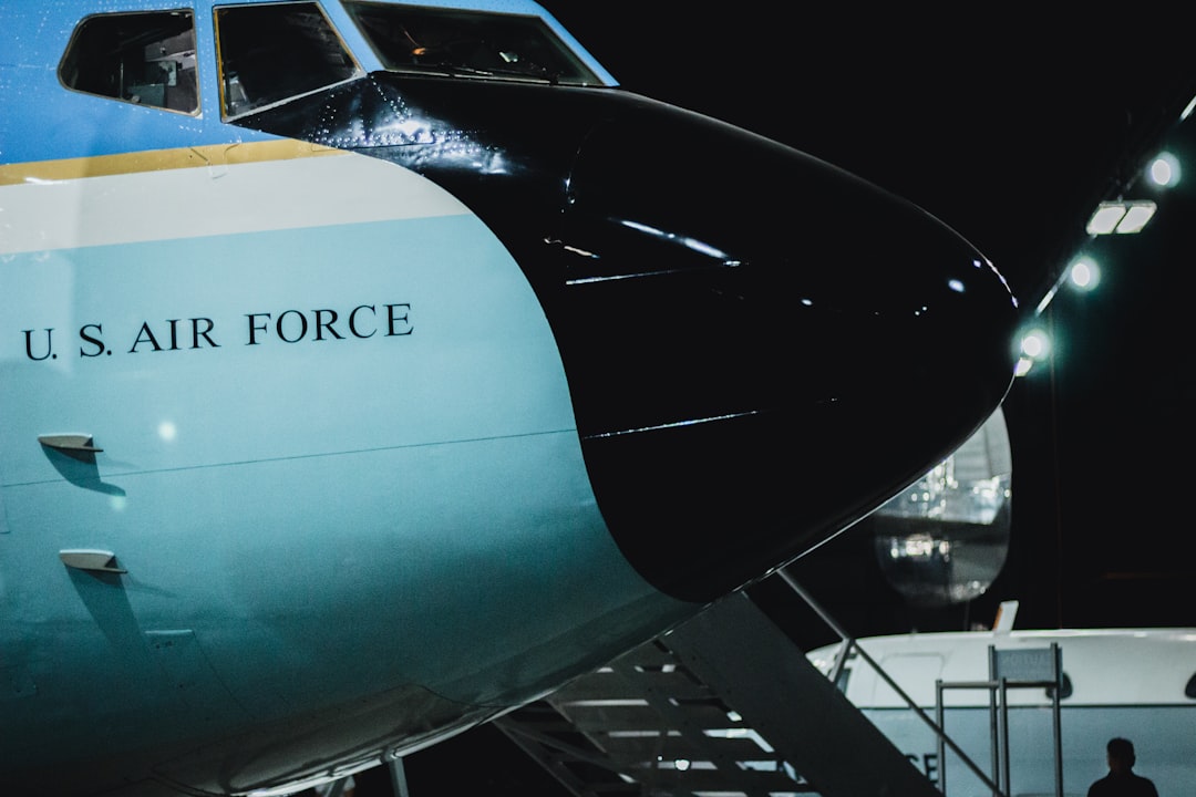 President Trump speaking at a podium with Air Force One in the background