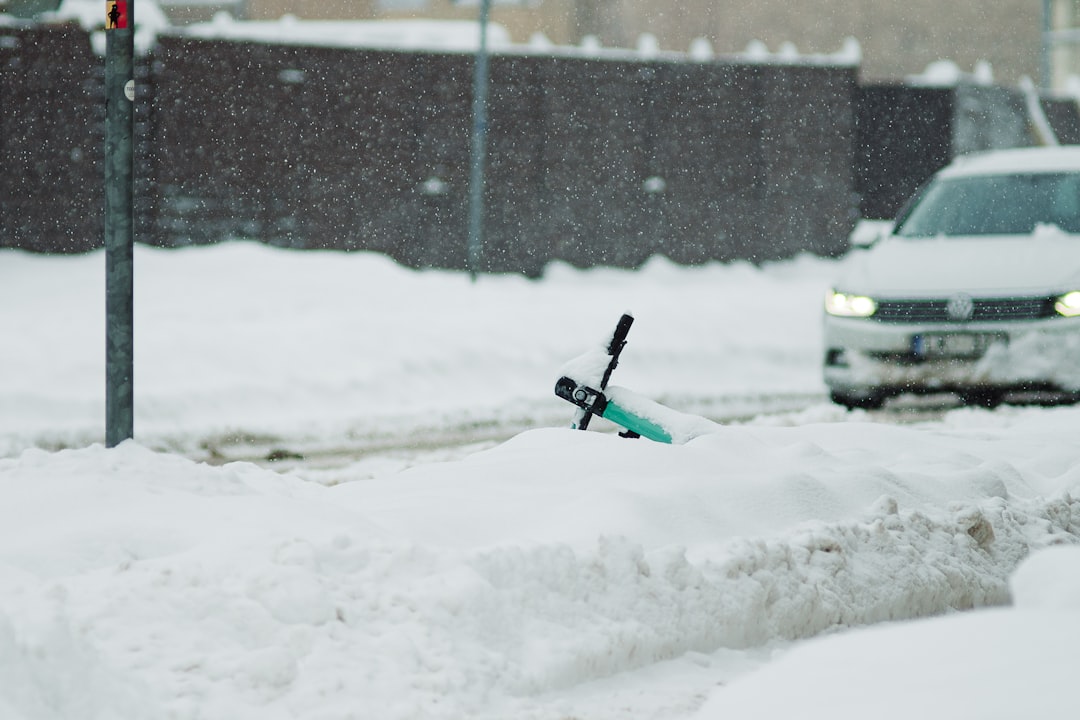 A robotic snow blower clearing a snowy driveway