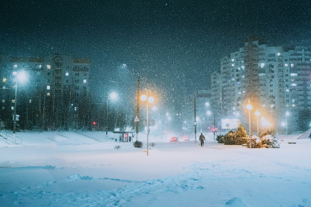 Snow-covered city street with empty shops