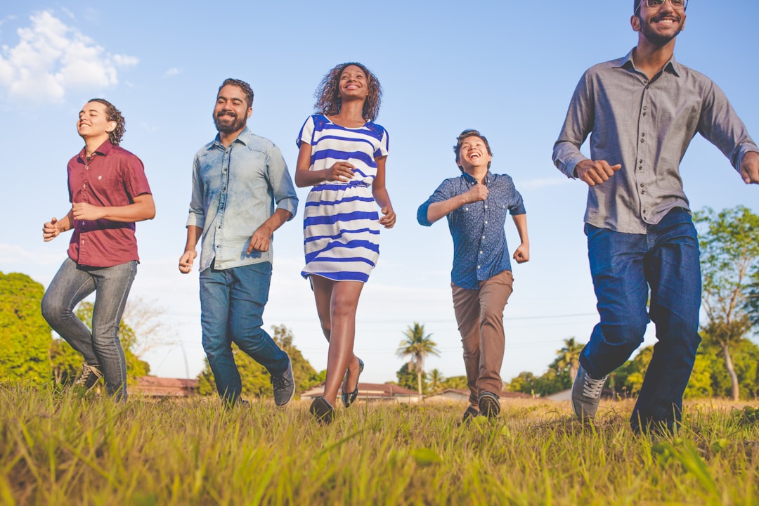 A group of diverse individuals walking in a park, representing light physical activity
