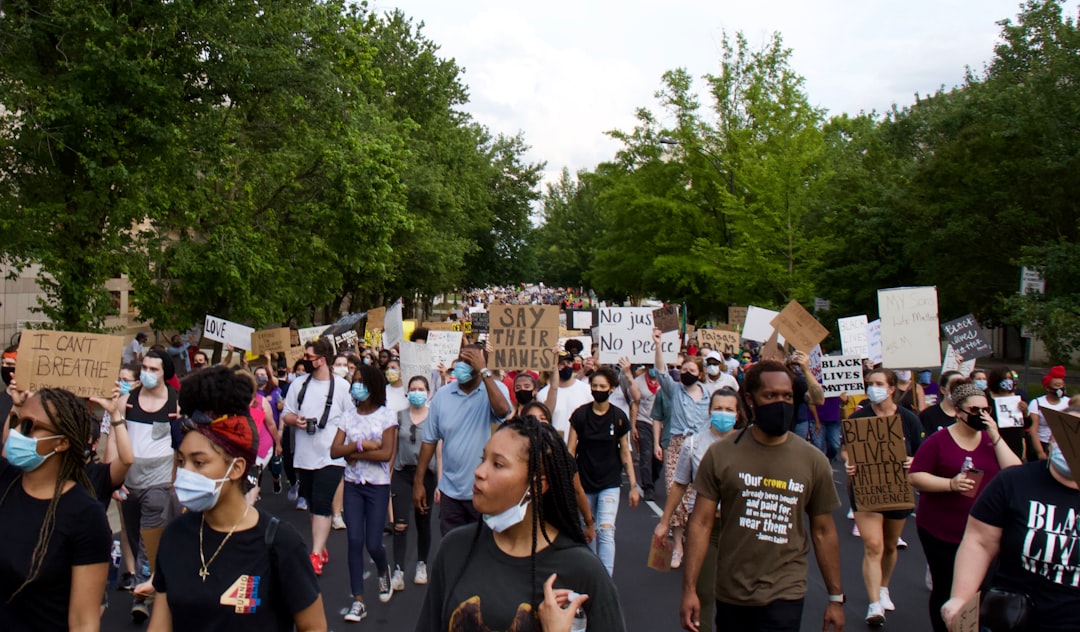 A protest or rally scene with people holding signs about immigration reform