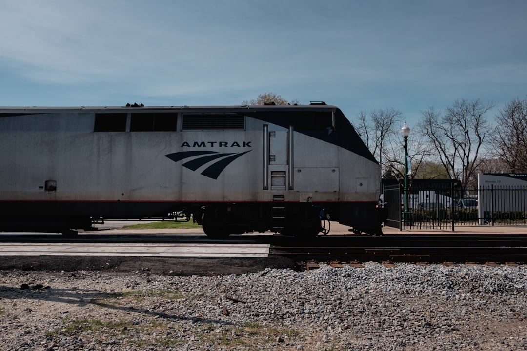 A bustling Amtrak station with travelers boarding a train