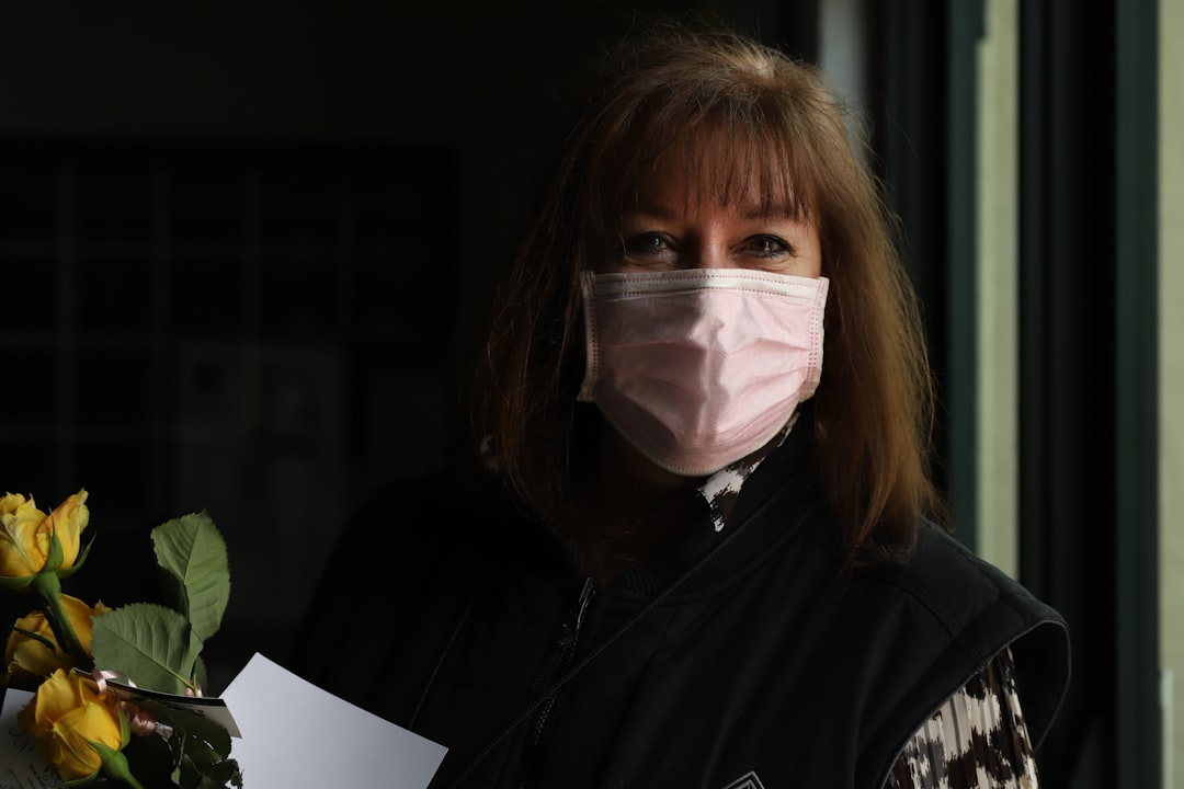 A person wrapped in blankets and surrounded by tissues