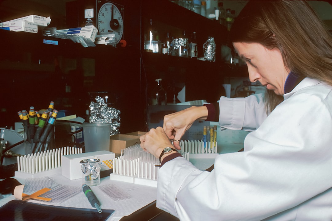 A laboratory scientist analyzing a blood sample under a microscope
